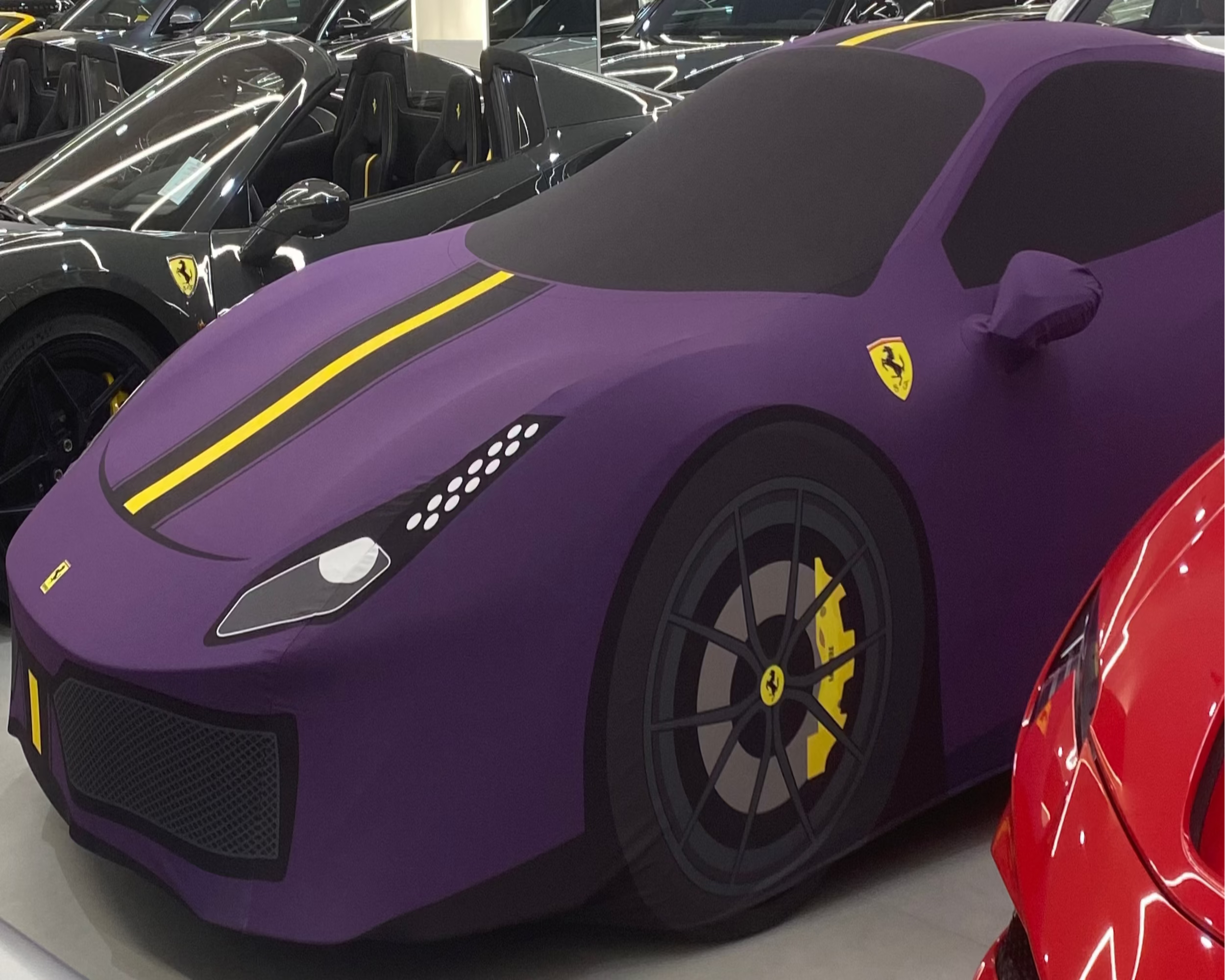 Purple Ferrari 488 Pista in a showroom with other cars in the background