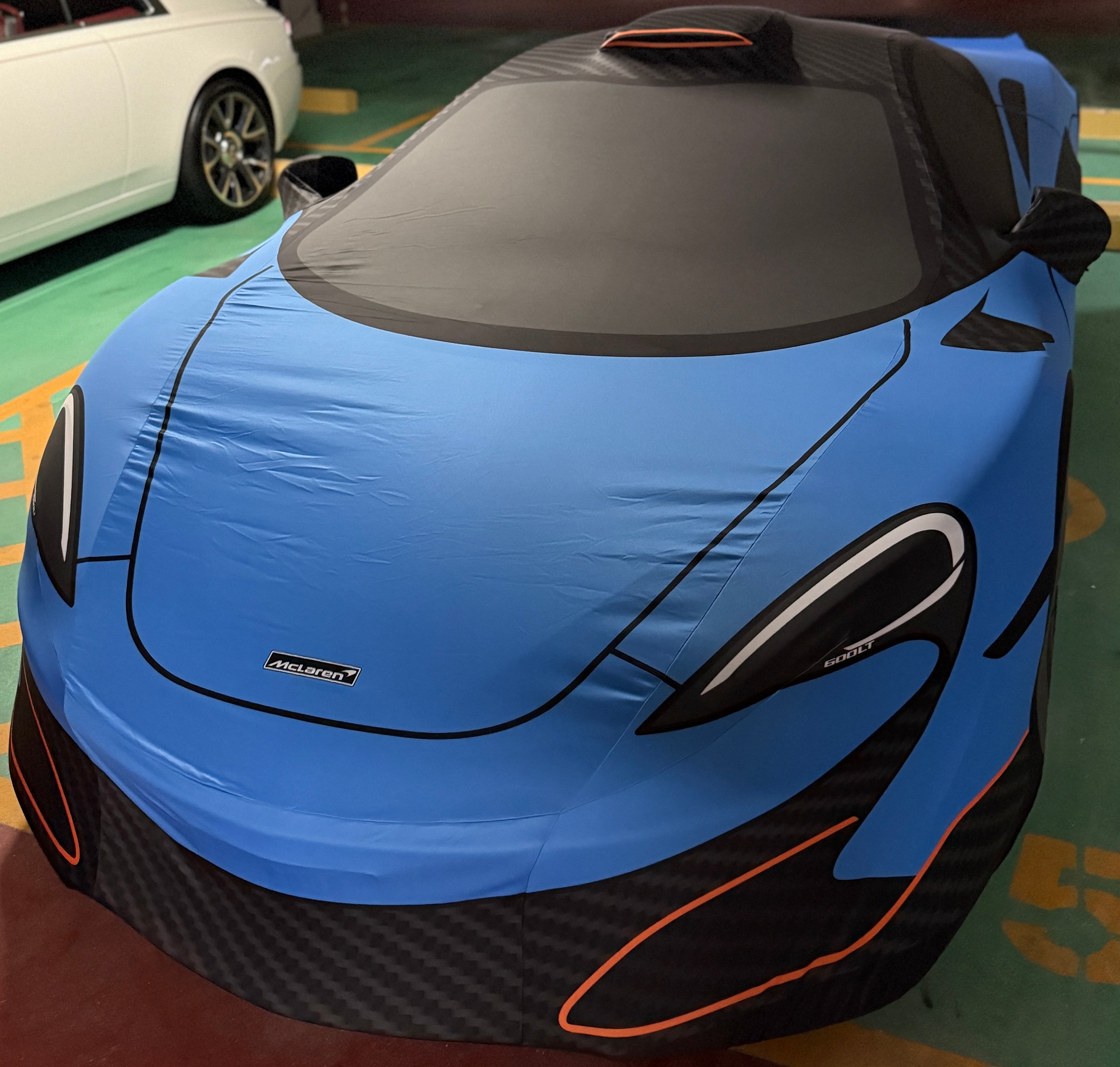 Bespoke TyreDox indoor car cover fitted to a blue McLaren supercar – premium elastic knit fabric protecting paintwork from dust, moisture and scratches